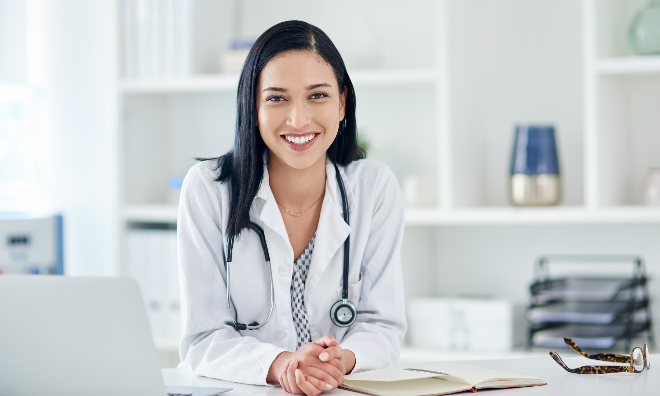 Portrait of a young doctor working at her desk