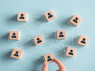 Building a strong team, Wooden blocks with people icon on pink background, working together concept